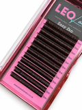 A close-up of false eyelash clusters in a pink and black tray labeled 'LEO eyelash supplies Easy fan'. The lashes are dark brown to black, arranged in rows on a bright pink backing card with size markings.