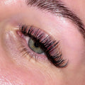 Close-up of green eye with premium lash extensions from Leo Lash Range