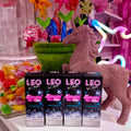 Leo Lash Range lash shampoo products displayed with colorful candy, glitter unicorn, and neon decor.