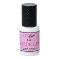 Eyelash adhesive bottle with pink label and black cap on white background