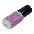 Pink and black eyelash adhesive tube on a white background