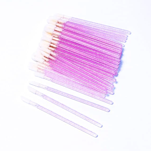 Pack of small pink lash brushes for eyelash extensions on white background